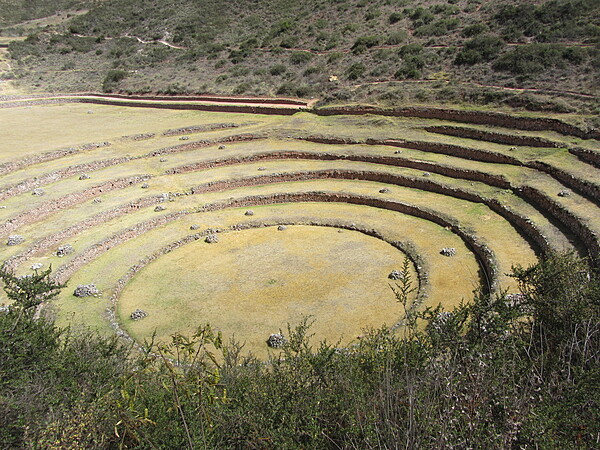 This huge series of concentric terraces in Moray (just west of the salt pans of Maras) served as an ancient agricultural research station. The distance from the highest to lowest ring is 150 m (490 ft), which allowed the Wari and later the Inca peoples to experiment with growing crops at different altitudes and exposure to the sun. The circular bottom is so well drained that it never completely floods, no matter how hard the rain.