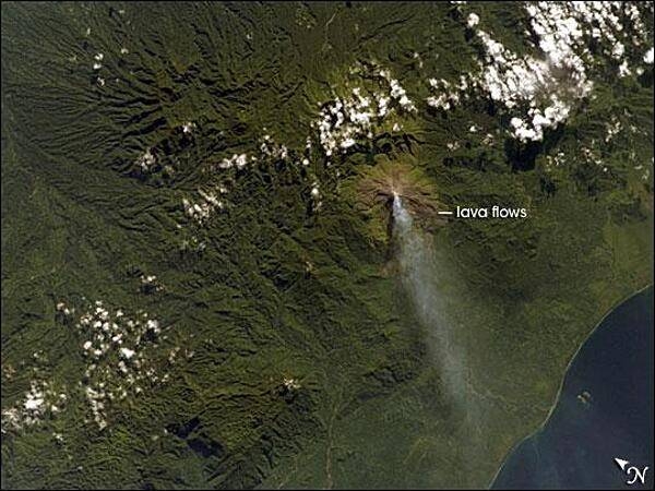 Although Bouganville Island is geographically part of the Solomon Islands chain, politically, the island is part of Papua New Guinea. Bouganville is typical of many Pacific Rim islands in that volcanism has played a large part in both its geological and recorded history. The island hosts three large volcanoes along its northwest-southeast trending axis: Mount Balbi, Mount Bagana, and the Mount Takuan volcanic complex. Mount Bagana, located near image center in this astronaut photograph, is the only historically active volcano on the island.

Within Bouganville's lush landscape, light green vegetation and brown lava flows mark the 1,750-meter-high lava cone of Mount Bagana. The lighter color of vegetation could result from volcanic activity, higher altitude, or both. The eruptive style of the volcano is typically non-explosive, producing thick lobes of lava that run down the flanks and maintain a dome in the summit crater. Occasional pyroclastic flows of rock fragments and volcanic ash have also occurred. This image shows a diffuse white vapor plume extending west-southwest from the summit. Photo courtesy of NASA.