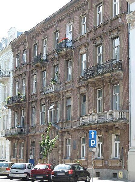 Interesting architectural details in the brick and stone facade of a Warsaw building.