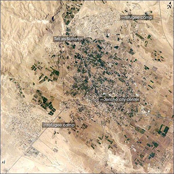 Commonly known as "the oldest city in the world," Jericho is an important historical, cultural, and political center located northwest of the Dead Sea. The city is perhaps best known from the Biblical story of a great victory over its Canaanite citizens by the Israelite leader Joshua. In the story, the walls of the heavily fortified city were destroyed with divine assistance (ca. 1400 B.C.). The site of ancient Jericho, known today as Tell es-Sultan, has been the focus of several archaeological excavations to investigate the Biblical story. The original settlement was built on a hill, or "tell." The results of these excavations suggest that the walls of Tell es-Sultan have been built and rebuilt many times, due mainly to collapse caused by earthquakes, which are common in the region. One of these events may be the basis for the story of Joshua. Modern-day Jericho is a popular tourist destination due to its pleasant climate, historical sites, and religious significance. This photograph shows the city center and the original settlement mound of Tell es-Sultan. Total distance across the image is approximately 8 km (5 mi). Two large refugee camps are located to the northwest and south of the city center. The high building density of the refugee camps contrasts sharply with the more open city center and irrigated fields (green polygonal patches) of Jericho, and illustrates one of the physical consequences of the ongoing Israeli-Palestinian conflict in the region. Photo courtesy of NASA.