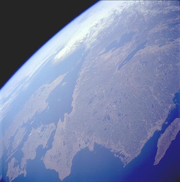 Southern Sweden, with its plethora of lakes, is visible in this west-looking, high-oblique photograph. The lakes were created when the continental glaciers scoured this area and then receded, allowing the countless depressions to fill with water. In addition to numerous smaller lakes that are generally aligned in a north-south orientation, two large lakes - larger Lake Vanern and Lake Vattern - can be seen toward the northern edge of the photograph. The dark green area inland from the coast is forested lands. Image courtesy of NASA.