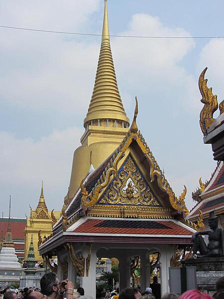 View within the Grand Palace in Bangkok showing the golden Phra Siratana Chedi. A chedi, or stupa, is a mound-like reliquary containing Buddhist relics. The chedi is on the grounds of the Temple of the Emerald Buddha.