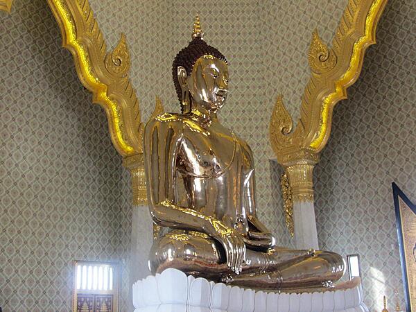 The Suhhthai Traimit Golden Buddha image is the largest Golden Buddha image in the world. Made of pure gold, it is 3 m (9.8 ft) tall and weighs 5.5 tons. The Buddha was probably constructed in the 13th or 14th centuries. At some point it was covered in plaster and painted to prevent its theft. Its origins were forgotten and it was brought to Bangkok from a ruined temple in Ayutthaya in the early 19th century. In 1955, the Buddha was dropped while being moved and part of its plaster covering broke revealing the gold underneath. In 2010, a new building was erected at the Wat Traimit Temple to house the Golden Buddha, which is valued at close to $300 million dollars.