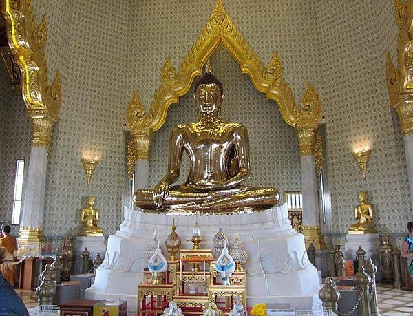 The Suhhthai Traimit Golden Buddha image is the largest Golden Buddha image in the world. Made of pure gold, it is 3 m (9.8 ft) tall and weighs 5.5 tons. The Buddha was probably constructed in the 13th or 14th centuries. At some point it was covered in plaster and painted to prevent its theft. Its origins were forgotten and it was brought to Bangkok from a ruined temple in Ayutthaya in the early 19th century. In 1955, the Buddha was dropped while being moved and part of its plaster covering broke revealing the gold underneath. In 2010, a new building was erected at the Wat Traimit Temple to house the Golden Buddha, which is valued at close to $300 million dollars.