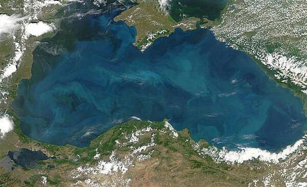Swirls of color ranging from deep olive green to bright turquoise were created by a massive phytoplankton bloom that covered the entire surface of the Black Sea on this image taken 20 June 2006. Many of Europe's largest rivers, including the Danube, the Dnister, and the Dnipro (Dnieper) dump fresh water into the sea. The sea's only source of salty water is the narrow Bosporus Strait (in the southwest), which connects it to the Mediterranean Sea through the Sea of Marmara. Northern Turkey makes up the southern shore of the sea. The diamond-shaped landmass that projects into the sea from the north is Ukraine's Crimean peninsula. Photo courtesy of NASA.