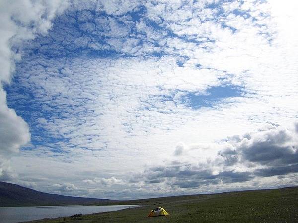 Phenomenal grandeur. Big sky and big clouds overhead dwarf a single tent set up in the wilderness for an archeology research project in Noatak National Preserve, Alaska. Photo courtesy of the US National Park Service.