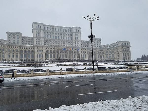 Exterior of the Palace of the People in Bucharest. The building was constructed between 1984 and 1997 on orders of Nicolae Ceausescu, the dictator of communist Romania. The structure is the world's third-largest building by floor area (after the Pentagon in Washington, DC and the Long'ao Building in China) with 1,100 rooms; it consists of 12 floors above ground and 8 floors below. The edifice hosts the two houses of Romania's Parliament (the Senate and the Chamber of Deputies), three museums, and an international conference center. Nonetheless, about two-thirds of the building remains unoccupied.