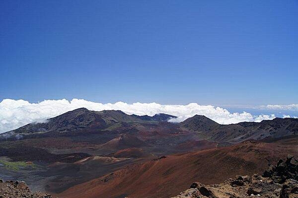 Multicolored cinder cones in Haleakala (House of the Sun) Crater on the island of Maui. The tallest peak on the mountain is 3,055 m (10,023 ft) above sea level, which is frequently high enough to overlook the clouds.