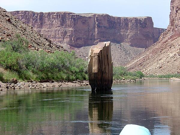 Ten-Mile Rock is a slab of sandstone embedded  in middle of the Colorado River in Marble Canyon section of the Grand Canyon. Image courtesy of the USGS.