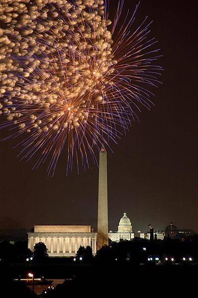 Fourth of July fireworks in Washington, DC; view of the Lincoln Memorial, the Washington Monument, and the US Capitol.