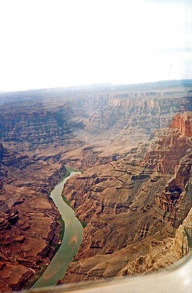 Areas of greenery along the banks of the Colorado River as it winds through the Grand Canyon in Arizona. In places, the canyon is 1.6 km (1 mi) deep.