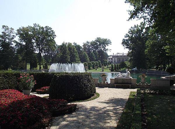 View of Nemours Mansion from beyond the Long Walk and Reflecting Pool. The Mansion was built in 1909-1910 by industrialist Alfred I. duPont and named after the French town from which his family emigrated in 1800.
