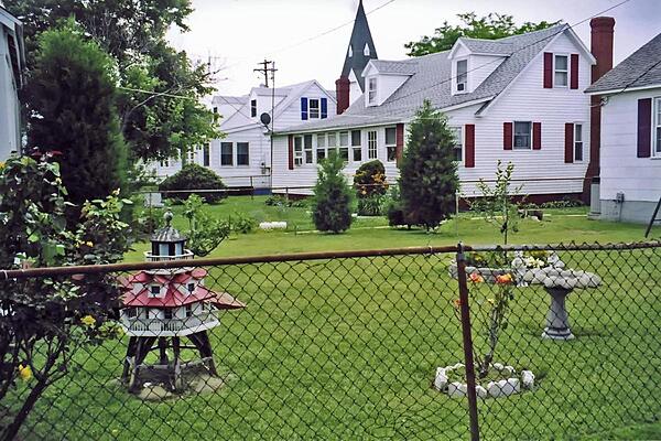 The front or back yards of homes on Tangier Island, Virginia are well tended. Miniature lighthouses decorate many a front or back yard.