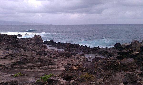 Kapalua Beach Trail on the island of Maui. The trail runs for 2.8 km (1.8 mi) along the Kapalua coast, passing white sand beaches, stunning homes, and lava flows, as shown in this picture.