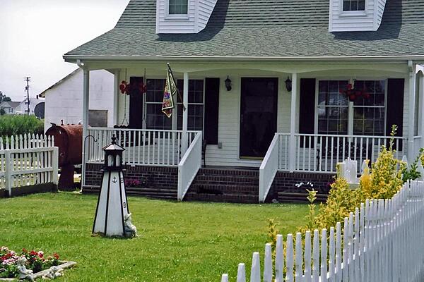 Tangier Island, Virginia is located in the lower Chesapeake Bay. This house is typical of the local architecture. House facades generally display white siding, while shutters and roofs are of matching colors.