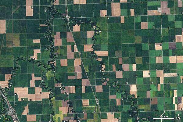 Farms in northwest Minnesota viewed from space resemble a patchwork quilt in this 10 September 2009 image. Fields change hue with the season and with the alternating plots of organic wheat, soybeans, corn, alfalfa, flax, or hay. Although lush green fields dominate the image, some crops have already been harvested leaving squares of tan and brown. Photo courtesy of NASA.