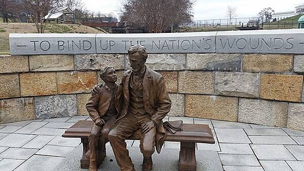 The statue of Abraham Lincoln at Richmond National Battlefield. On 4 April 1865, just after Union troops took control of Richmond, Virginia, the Confederate capital, President Lincoln and his 12-year-old son Tad toured the hostile city. This full-size bronze grouping symbolizes that moment in time, as depicted by sculptor David Frech. Behind the figures is a phrase from Lincoln's Second Inaugural Address, delivered one month before: “To bind up the nation’s wounds.” Amazingly, Lincoln survived this dangerous visit, only to be murdered by a Confederate activist in Washington just 10 days later. Photo courtesy of the National Park Service.