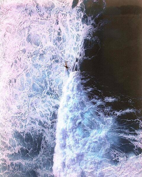 Solitary surfer along the North Shore of the Big Island of Hawaii.