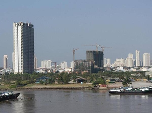 View of Ho Chi Minh City (aka Saigon) from the Saigon River. Saigon is Vietnam's major port and, with 8 million inhabitants, its largest city. It was called Saigon until 1975 when it was renamed Ho Chi Minh City following its capture by North Vietnamese communist forces. Although the city's commercial core is officially called Saigon, the entire city is widely referred to as Saigon even in the North. The city was architecturally influenced by the French during their colonial occupation of Vietnam. Numerous classical Western-style building in the city reflect this, so much so that Saigon was referred to as "The Pearl of the Far East" or "Paris in the Orient." In more recent years, a building boom has transformed the skyline of the city.