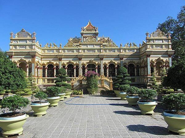 Vinh Trang Pagoda near the city of My Tho. Known of the "Gateway to the Mekong Delta," My Tho, with a population in excess of 200,000, lies on the My Tho River, a branch of the Mekong River, 70 km (45 mi) south of Saigon (Ho Chi Minh City).  First completed in 1851, the Vinh Trang temple has been reconstructed a number of times.