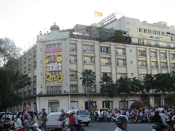 The Rex Hotel in Saigon (Ho Chi Minh City) was built in 1927 as a two-story auto dealership and garage complex. The building was renovated from 1959 to 1975 into a 100-room hotel with three movie theaters, a cafeteria, dance hall, and library. The hotel was made famous during the Vietnam War when it hosted the American military command's daily press conference dubbed by skeptical journalists as the "Five o'clock Follies." The rooftop bar was a well-known gathering spot for military officials and war correspondents.