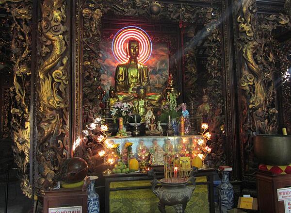 Shrine in the interior of the Vinh Trang Pagoda near the city of My Tho. Known of the "Gateway to the Mekong Delta," My Tho lies on the My Tho River, a branch of the Mekong River, 70 km (45 mi) south of Saigon (Ho Chi Minh City). First completed in 1851, the Vinh Trang temple has been reconstructed a number of times.