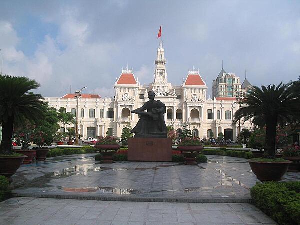 Statue of Ho Chi Minh reading to a child in front of the City Hall in Saigon (Ho Chi Minh City). Built by the French between 1898 and 1908, the beautifully ornamented structure is officially known as the Ho Chi Minh City People's Committee Building and is not open to the public.