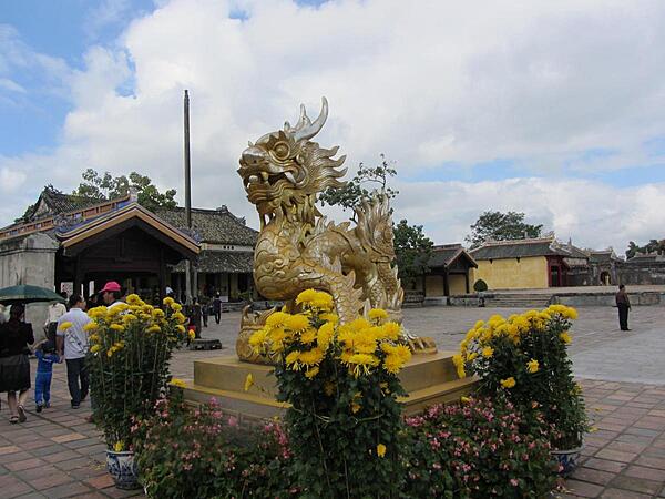 Figure on the grounds of the former Imperial City in Hue. Located on the Perfume River in central Vietnam, Hue was the capital of Vietnam from 1802 until 1945. A walled citadel, 2 km by 2 km, as well as a moat, surrounded the city. Inside the citadel was the Imperial City. Many of the buildings of the Imperial City were destroyed during the Vietnam War. Some reconstruction has begun.