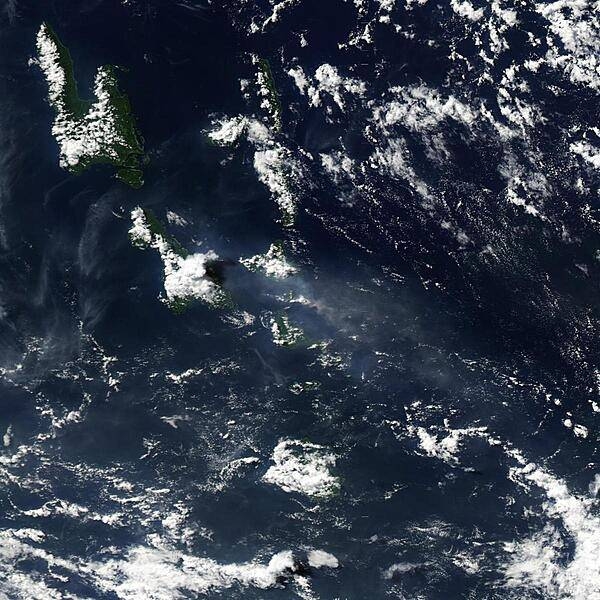 Vanuatu's Lopevi Volcano released a plume on 3 May 2007 (center of photo) that was captured by NASA's Aqua satellite. The US Air Force Weather Agency reported an extensive area of vog resulting from the volcanic eruption. When gases from a volcano - particularly sulfur dioxide - react with oxygen, water, dust, and sunlight, volcanic smog (or vog) results. Besides Lopevi and its neighboring islands, this image shows the volcanic plume blowing westward away from the volcano. The plume appears as a small, mostly opaque puff of gray-beige. The resulting area of vog, which appears as a more transparent, dingy-gray haze, dwarfs the diminutive plume. Lopevi is a stratovolcano composed of alternating layers of solidified lava, hardened ash, and volcanic rocks. One of the island nation's most active volcanoes, this volcanic island is only about 7 km (4 mi) wide. Eruptions have been recorded at Lopevi since the middle of the 19th century. Vanuatu's two major islands of Espiritu Santo and Malakula appear in the upper left. Image courtesy of NASA.